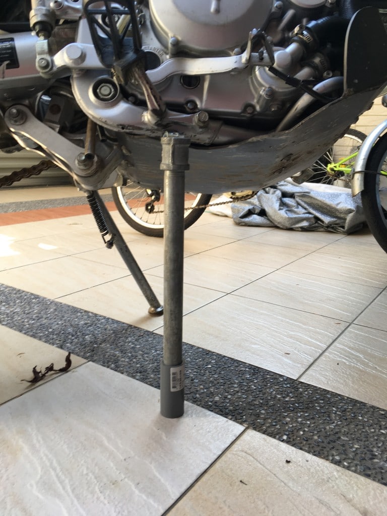 Metal pipe holding up motorcyle
