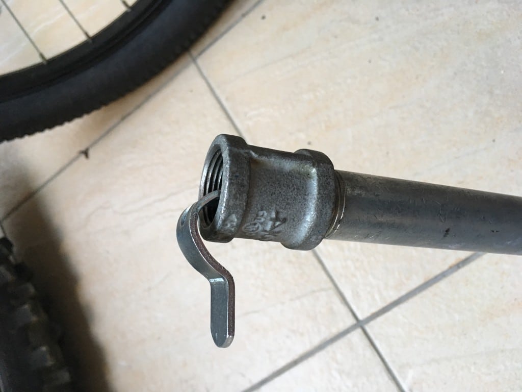 Metal pipe with connector and bent metal piece stuck inside