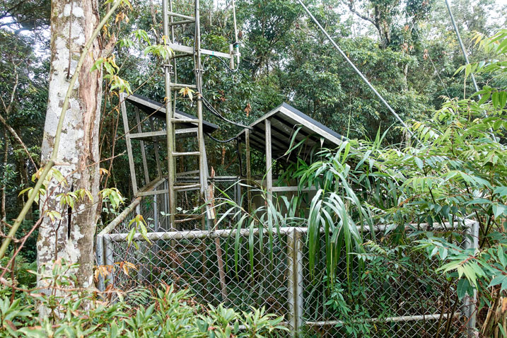 Fenced off area with tall antenna and solar panels