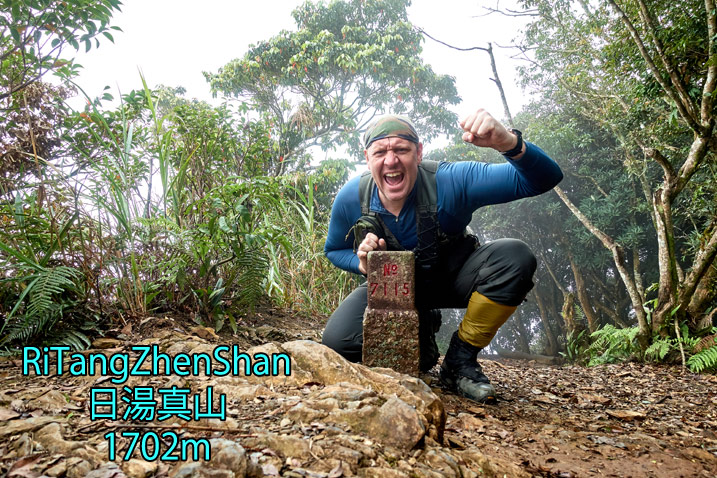 Man in triumphant post behind triangulation marker