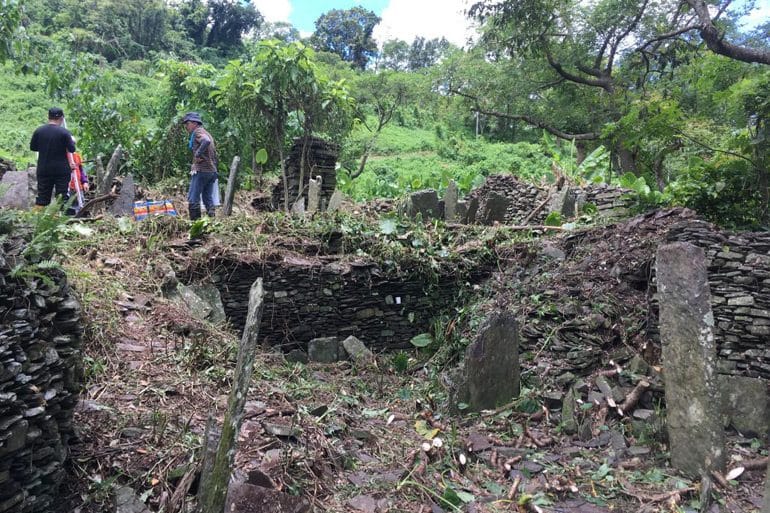 Workers excavating an abandoned village in ruins