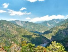 mountain landscape and river - blue sky and clouds
