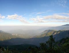 Panoramic view of mountains - blue sky and white clouds - village in distance