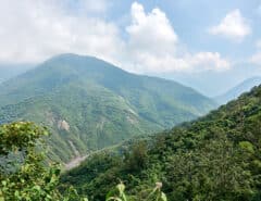 Mountains, blue sky and white clouds - riverbed below