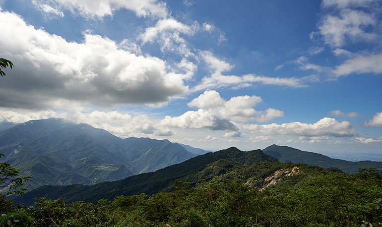 Mountains, white clouds, and blue sky